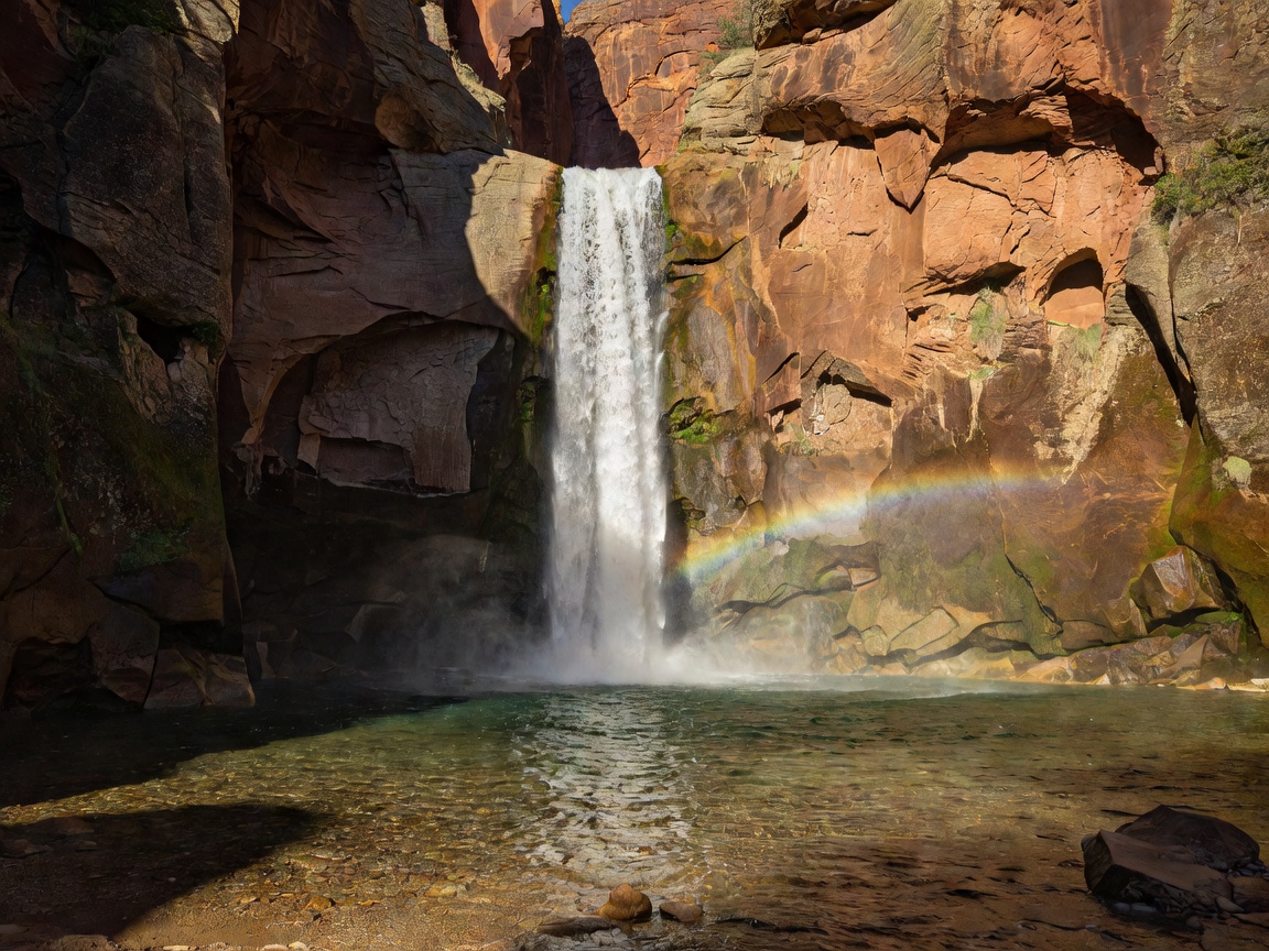 Emerald Glen Plunge Pool falling vertically into crystal clear basin surrounded by canyon walls